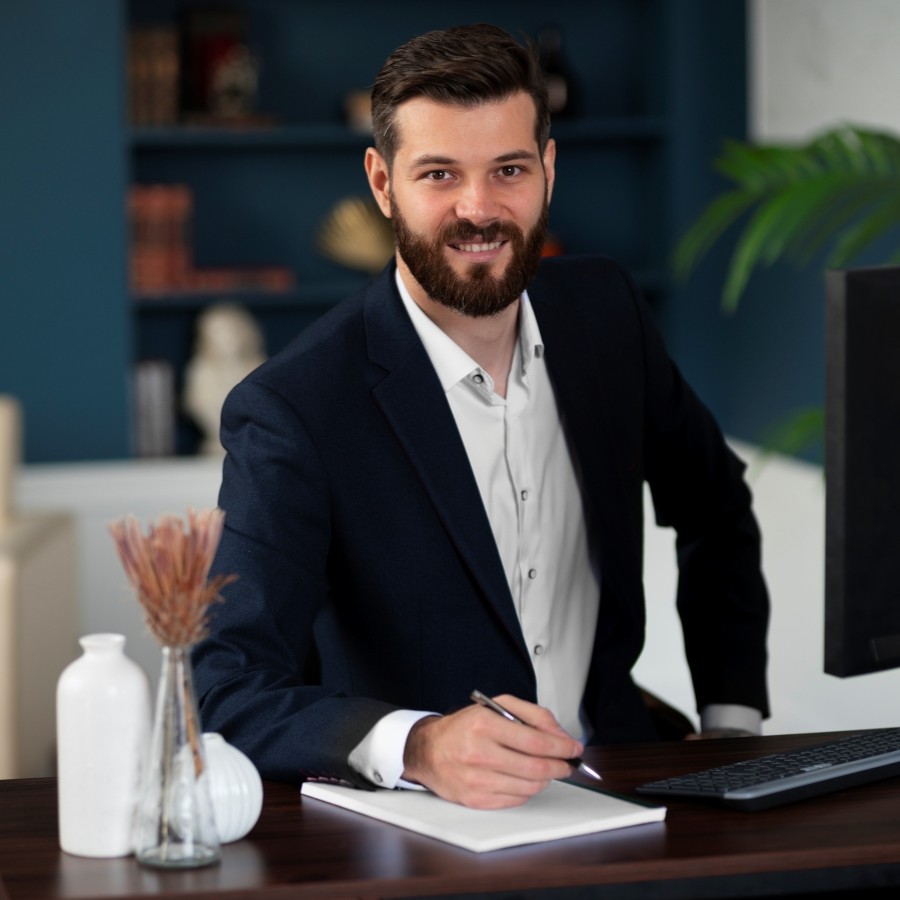 medium-shot-smiley-man-sitting-desk